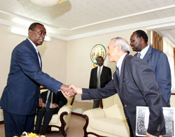 Adam Iskounen the General Manager of Singaporean firm PORTEK (R) greets PM Bernard Makuza as Trade and commerce minister Francois Kanimba looks on (Photo T.Kisambira)