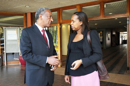 AfDB resident representative, Negatu Makonnen (L), chats with MINECOFIN PS, Pichette Kampeta after the opening of a joint government and AfDB portfolio review July 20, 2011. (The New Times/John Mbanda) 