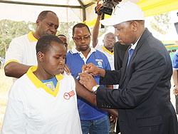 Bureima Hama Sambo (R) representing One UN Rwanda immunises a young girl during the second phase of the Cervical Cancer immunisation campaign in Nyagatare District on Tuesday. Government will soon embark on screening of mature women (Photo J Mbanda)