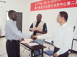 Lin Yingxing the centre manager where the training was conducted (R) hands a certificate to one of the  participants  (Photo JP Bucyensenge)