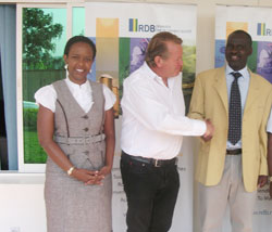  NFC Boss Julian Ozanne (c) with  the Minister Kamanzi of Natural Resources as RDB's Clare Akamanzi looks on after signing the agreement, yesterday. (Courtesy Photo)