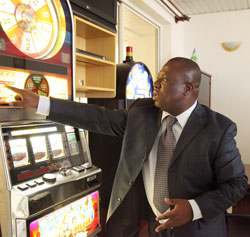  Philippe Brizoua, the head of Rwanda Gaming Corporation points at a slot machine. (File Photo)