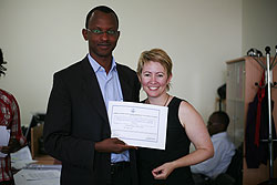  A trainee (L) receives a cerfiticate of participation from Kellie Krake of International Bridges to Justice (Courtesy Photo)
