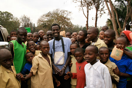 Sylvain with Rwandan children in the countryside.