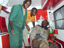 Trailer driver, Kevin Shazima 24, recieves treatment after being trapped in the truck. (Photo D.Sabiiti)