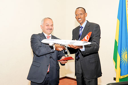 President Paul Kagame with the chief executive of Turkish Airlines, Temel Kotil, hold a model plane after  their meeting at Village Urugwiro yesterday. The New Times /Village Urugwiro