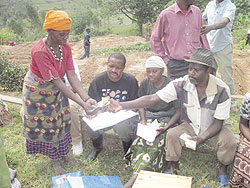 Nyirabagenzi receives a small loan from her association. The NewTimes/ L. Nakayima
