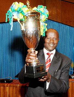 Rulindo mayor Justus Kangwagye holds the trophy won by his district in the 2010 11 Performance contracts yesterday