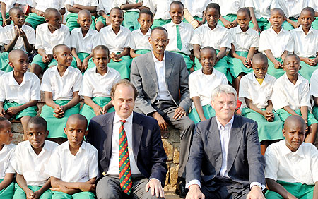  President Paul Kagame, the UK Secretary of State for International Development, Andrew Mitchell (R) and Brooks Newmark in a group photo with children after commissioning Girubuntu Primary School, built with support from the UK Conservatives. The New Time