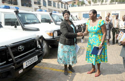 The Minister of Health, Dr. Agnes Binagwaho (L), receives a donation of the new ambulances from the UNFPA country Representative, Victoria Akyeampong. The New Times/John Mbanda 