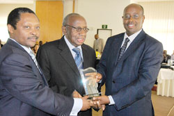 Executive Secretary of Rwanda Governance Advisory Council Prof. Anastase Shyaka (L) and Local Government Minister James Musoni (R) award Prof. Petero Rwanyindo of IRDP. The New Times /John Mbanda