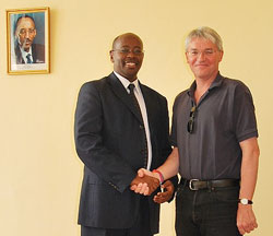 Ministers James Musoni  with Andrew Mitchell pose for a photo after their meeting at the MINALOC Headquarters yesterday. The New Times.Courtesy