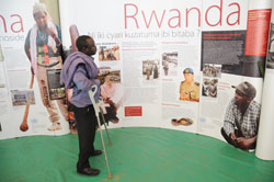  A man keenly examines pictures that reflect the 1994 Genocide  against Tutsi recently.Ibuka has called for more value to Genocide crimes. The New Times File.