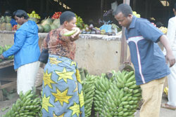 A man buys Bananas from Kimironko market. EAC boss has called for the implementation of strategies designed to ensure food security in the region. The New Times / File.