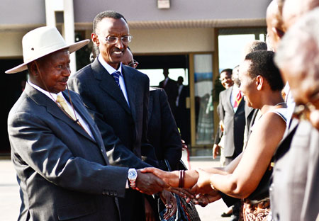 Presidents Museveni (L) and Kagame greet officials at Kigali International Airport yesterday shortly before the former's departure after a four-day state visit to Rwanda. The New Times / James Akena