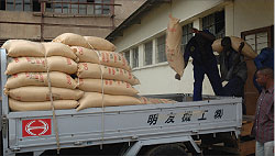 Workers at Kabuye sugar load a truck with sacks of sugar. The New TImes./J.Mbanda