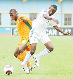 Charles Tibingana (R) fights for the ball with an Ivory Coast player during the 2011 Africa Junior Championship. The New Times/File.