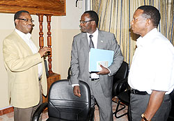  L-R;Kigali Bus Service (KBS)  Chairman Charles Ngarambe, Kigali City Mayor Fidel Ndayisaba and  Dodo Twahirwa of ATRACO in a chat after the meeting. The New Times /John Mbanda.