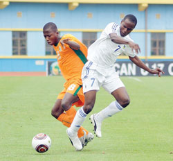 Charles Tibingana (R) fights for the ball with an Ivory Coast player during the 2011 Africa Junior Championship. The Uganda based winger has been called to the senior team. The New Times / file