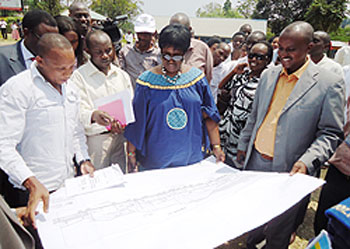  Dr Agnes Binagwaho (C) examines the proposed master plan of the new hospital to be built in Karongi beginning next month. The New Times Sam Nkurunziza