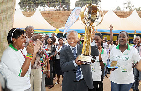 SORWATHE Director General Cally Alles carries the trophy high as he celebrates with his staff after the company emerged overall best exhibitor. The New Times /John Mbanda.