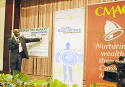 Celestin Rwabukumba facilitates trading at the RSE during the cross listing of Nation Media Group The New Times /J. Mbanda