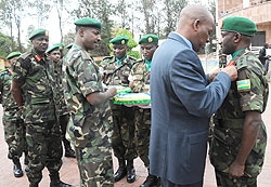 General Sekuba Konate decorates Col. Sam Baguma as Chief of Defence Staff Lt. Gen. Charles Kayonga (C) and the Chief of staff of the Reserve Force Lt. Gen Fred Ibingira look on yesterday. The New Times/John Mbanda