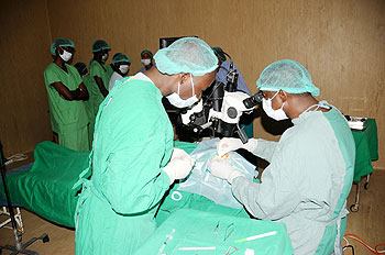 Lt. Col. Dr John Nkurikiye (R) performs a  Cornea transplant on an eye patient in Kanombe Miltary hospital on Thursday. The New Times /John Mbanda.