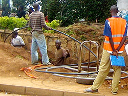 Workers lay fibre optic cables. The infrastructure will help bring down costs. The New Times /File