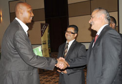 MINAGRI PS Ernest Ruzindaza (L) greets Yasir Syed, the Director of Biofert as Eagle Eye Africa Director Imran Morani looks on during the launch of the eco-friendly fertilizers, in Kigali, yesterday. The New Times /John Mbanda.