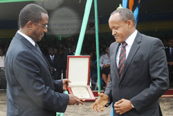 Senate President Vincent Biruta (L) awards the Chairman of the PSF Faustin Mbundu on tax payers' day last week. A new system will enhance tax collection The New Times /John Mbanda.
