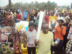 Thousands of Catholic faithful held placards with images of the Virgin Mary as they trekked to Kibeho to celebrate the Assumption Day. The New Times /Daniel Sabiiti.