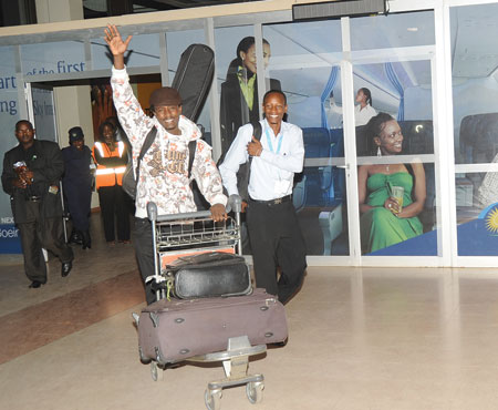 I AM THE CHAMPION! Alpha emerges from the arrivals terminal of the Kigali International Airport.
