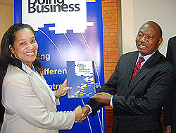 World Bank Operations Office,r Maria Miller, hands over a copy of the 2011 Doing Business in the EAC Report to the EAC Deputy SG in Charge of Planning, Dr. Enos Bukuku. The New Times /Courtesy