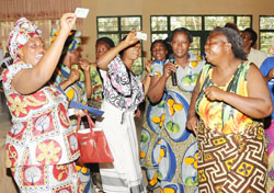  Congolese women celebrate after recieving  refugee identity cards in May last year. The New Times /File phot 