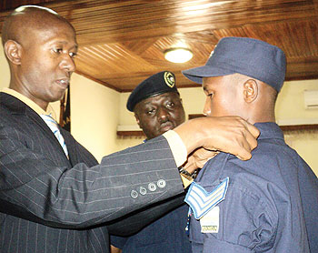 Internal Security Minister Fazil  Harelimana Commissions Frank Bizimungu after he was promoted for showing exemplary honesty when he picked and returned $40,000 at Kigali International Airport  The New Times / J. Mbanda