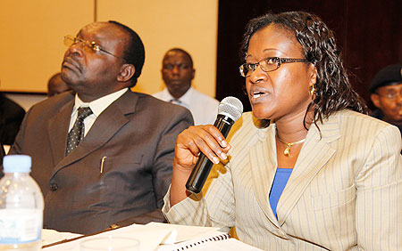 The Minister for EAC Affairs,Monique Mukaruliza (R) addreses the validation meeting as Minister Kanimba of Trade and Industry, looks on. The New Times/Timothy Kisambira
