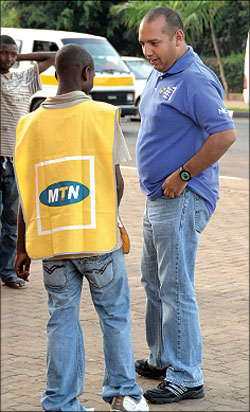 STIFF COMPETITION: Diego Camberos, Tigos acting CEO talks to an MTN vendor at a past Tigo Rwanda event. The New Times / File