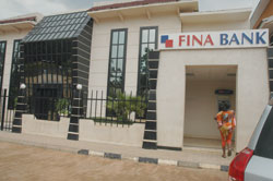 A FINA Bank customer accessing the banku2019s ATM machine. The New Times / File