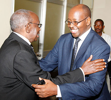 Prof. Peter Rwanyindo Ruzirabwoba of local think tank IRPD (L), welcomes Local Government Minister, James Musoni,  to the meeting yesterday. The New Times /Timothy Kisambira