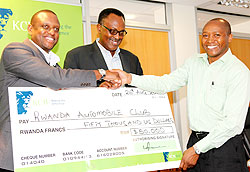 KCBu2019s Managing Director Maurice Kayibanda shakes hand with RAC boss Yves Kagina after signing a $50000 sponsorship deal for Rwanda Mt. Gorilla rally. The New Times/Timothy Kisambira.