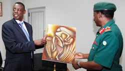 Defence Minister General James Kabarebe hand over a gift to General Davies Mwamunyange the Tanzanian army Chief of Defence Forces. The New Times/T.Kisambira
