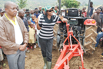 Agriculture Minister, Dr. Agnes Kalibata (R), presenting tractors to farmers as Ngoma Mayor Francois Ntiyitwagira looks on. The New Times/ S.Rwembeho