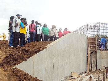 Deputy speaker, Polisi Denis (in jacket) inspecting one of the water channels under construction as other MPs look on. The New Times / D. Ngabonziza 