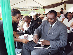 Trade and Industry Minister Francios Kanimba  enjoys the taste of Rwanda coffee served by Bourbon Coffee at the Cup of Execellence event. The New Times/ Daniel Sabiiti.