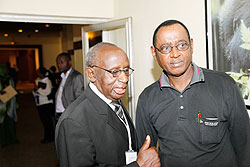 Prof. Peter Rwanyindo Ruzirabwoba (L) of local think tank IRPD  welcomes a participant at the launch of the IRDP report last Friday. The New Times/ File Photo