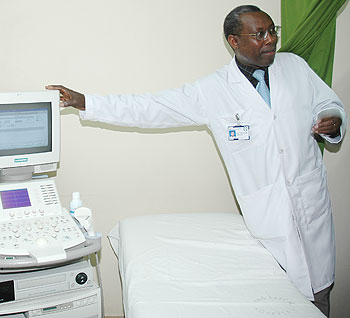 Dr Joseph Mucumbitsi shows off one of the heart machines at King Faisal hospital. He has called for a larger cardiac centre in the country. The New Times /File photo