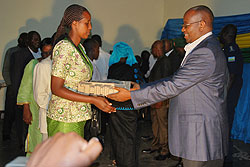  Local Government Minister James Musoni hands a laptop to one of the cell leaders in Rubavu over the weekend. The New Times/ Courtesy.
