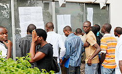 SFB students check the results of their exams on a notice board. The university is the first to embrace the uniform EAC academic calendar. The New Times /Timothy Kisambira