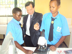 Japanese envoy to Rwanda Kunio Hatanaka engages students in laboratory tests during the commissioning of eight new classrooms at Kayonza Modern School The New Times /Stephen Rwembeho.
